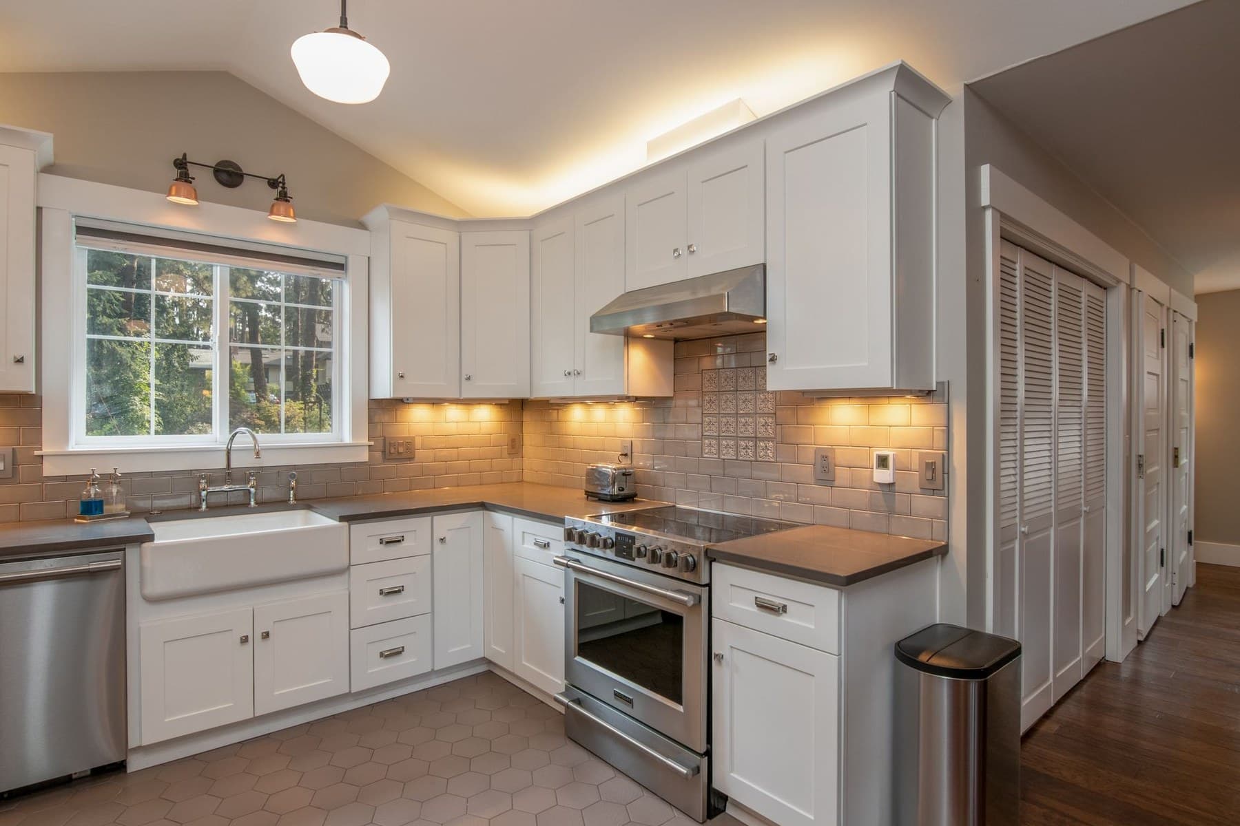 Representative finished kitchen with cabinetry, counters, and lighting