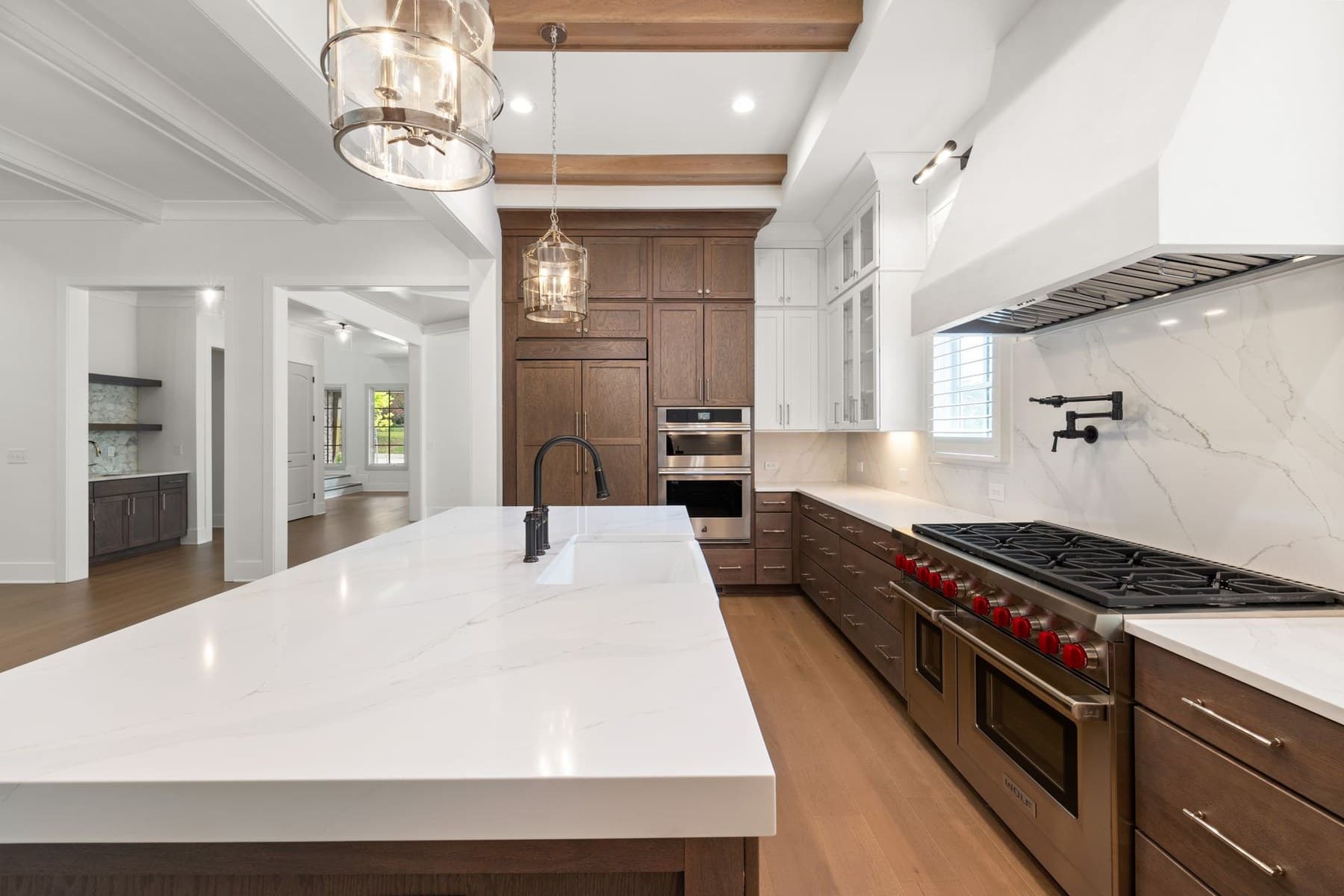 Representative kitchen cabinetry, island, lighting, and finish detail