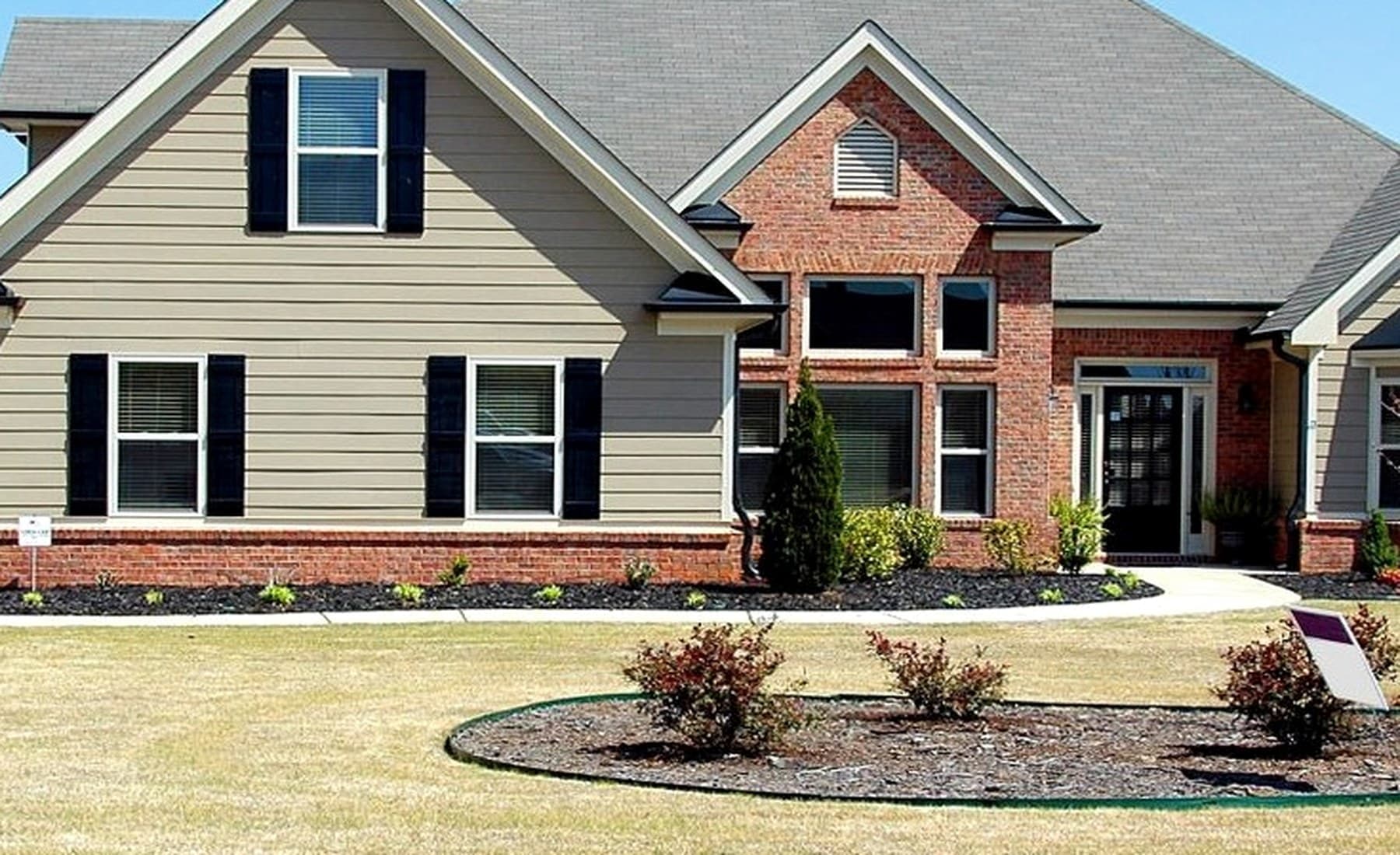 Representative residential facade showing multiple window groups and surrounding exterior conditions